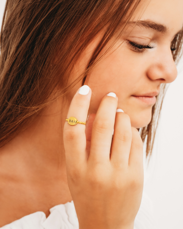 Gouden vintage initial ring om vinger