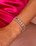 model draagt zilveren armbanden met roze details