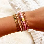 Gouden armparty met roze en gouden armbanden