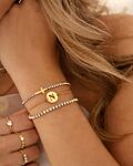 Gouden armparty met tennis armbanden