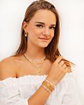 Gouden zomerse sieraden look bij meisje met bruin haar 
