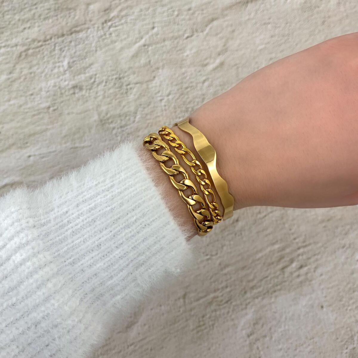 Gouden schakelarmbanden gemixt met bangle