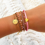 Gouden armbanden mix met roze en wit