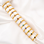 Gouden geboortesteen ringen op satijn