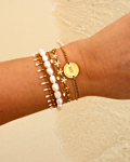 Gouden armparty met witte touch