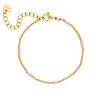 Gouden armband met roze bolletjes 